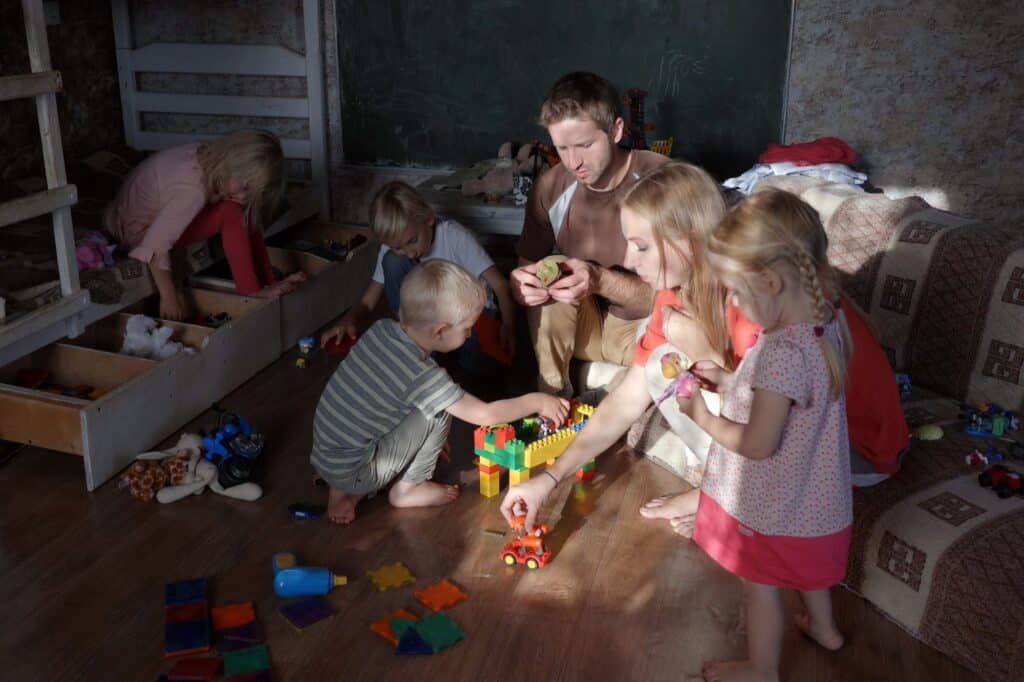 A young family organising toys