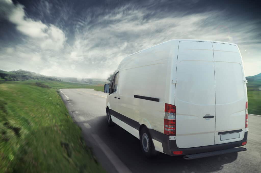 Man And Van on the road in a sunny day