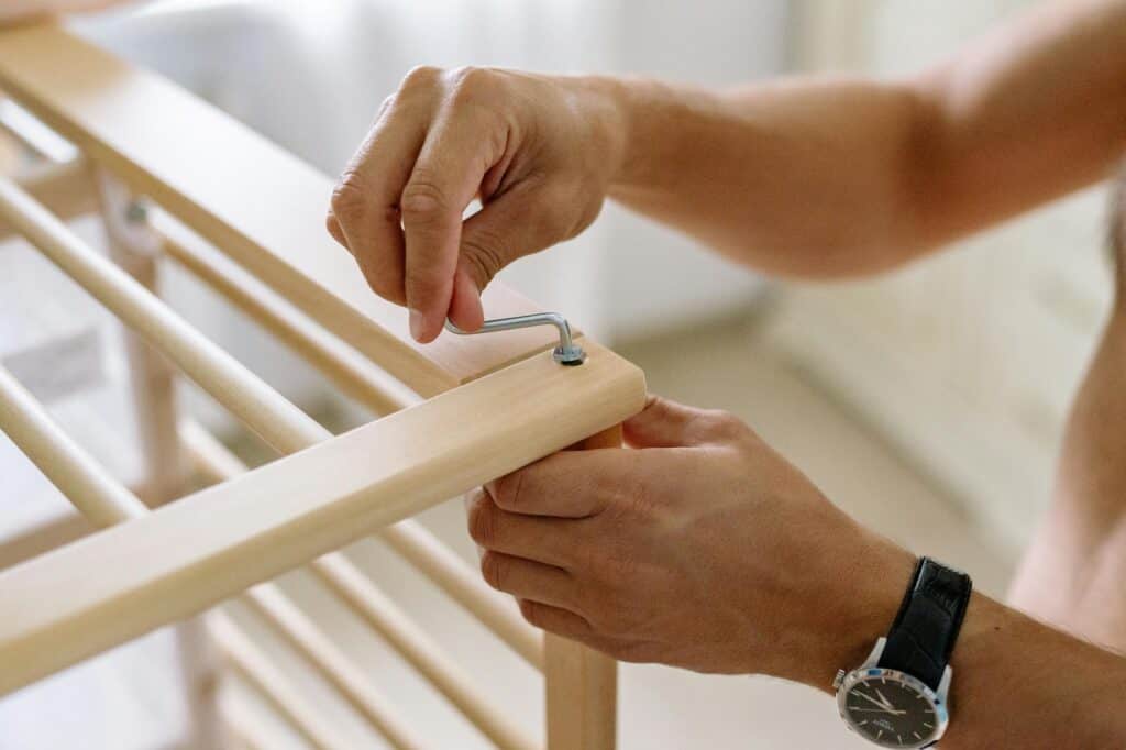 Closeup of a man's hand while assembling furniture