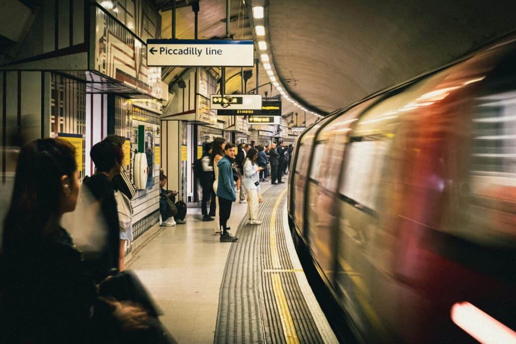 A subway station full of people with an incoming train