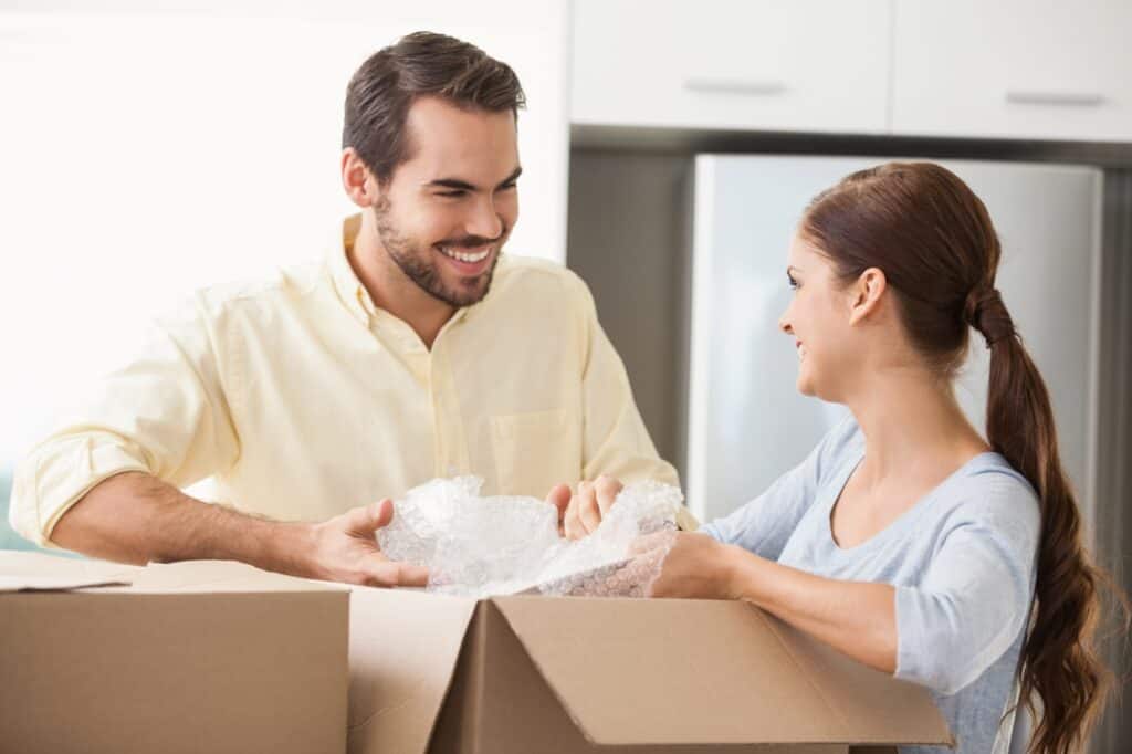 A young couple unpacking in the kitchen