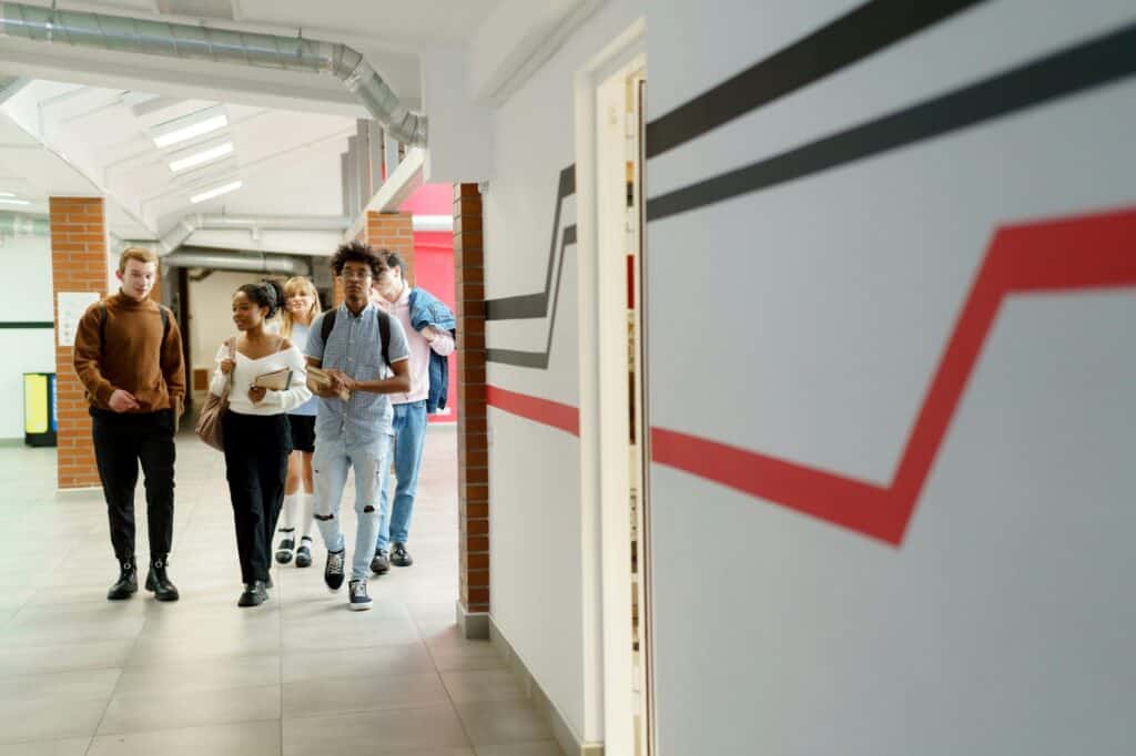 Secondary school students walking the school's hallway