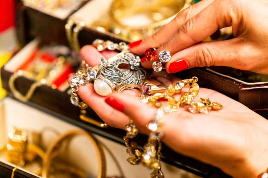 Cropped image of a woman holding different pieces of jewellery